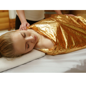 woman receiving a body wrap treatment